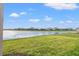 Spacious backyard with a lake view and lush green grass at 5414 Mystic Water Cv, Bradenton, FL 34211