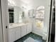 Bathroom with double vanity, large mirror, and a walk-in shower at 5601 Blount Ave, Sarasota, FL 34231