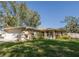 House exterior featuring a one-story home with a garage and landscaped yard at 5601 Blount Ave, Sarasota, FL 34231