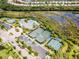 Aerial view of community pool, tennis courts, and clubhouse at 5610 Rain Lily Ct, Sarasota, FL 34238