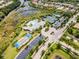 Aerial view of community with pool, tennis, and bocce at 5610 Rain Lily Ct, Sarasota, FL 34238