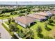 Aerial view of a house with a large backyard and lake in background at 5610 Rain Lily Ct, Sarasota, FL 34238