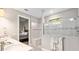 Bathroom with double vanity, shower, and view into bedroom at 5610 Rain Lily Ct, Sarasota, FL 34238