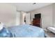 Bedroom with a dresser, TV and ensuite bathroom at 5610 Rain Lily Ct, Sarasota, FL 34238