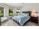 Bright bedroom with a queen-size bed and large windows at 5610 Rain Lily Ct, Sarasota, FL 34238