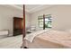 Spacious bedroom with a post bed, dresser, and crib at 5610 Rain Lily Ct, Sarasota, FL 34238
