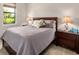 Cozy bedroom with a queen-size bed and wood nightstands at 5610 Rain Lily Ct, Sarasota, FL 34238