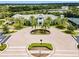 Community clubhouse with palm trees and circular driveway at 5610 Rain Lily Ct, Sarasota, FL 34238