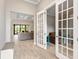 Open concept entryway with French doors to living room and study at 5610 Rain Lily Ct, Sarasota, FL 34238