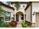 Elegant entryway with arched doorway and stone accents at 5610 Rain Lily Ct, Sarasota, FL 34238