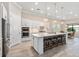 Gourmet kitchen boasts white cabinetry, quartz countertops, and a large island at 5610 Rain Lily Ct, Sarasota, FL 34238