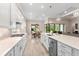 Modern kitchen with white cabinets, stainless steel appliances, and eat-in dining area at 5610 Rain Lily Ct, Sarasota, FL 34238