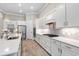 Clean kitchen featuring white cabinets, stainless steel appliances, and quartz countertops at 5610 Rain Lily Ct, Sarasota, FL 34238