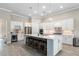 Bright kitchen with white cabinets, stainless steel appliances, and ample counter space at 5610 Rain Lily Ct, Sarasota, FL 34238