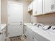 Laundry room with washer, dryer, and cabinets at 5610 Rain Lily Ct, Sarasota, FL 34238