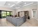 Spacious living room featuring a large sectional sofa and built-in shelving at 5610 Rain Lily Ct, Sarasota, FL 34238