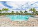 Inviting resort-style pool surrounded by palm trees and lounge chairs at 5610 Rain Lily Ct, Sarasota, FL 34238