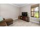Comfortable sitting room with sectional sofa and large TV at 5610 Rain Lily Ct, Sarasota, FL 34238