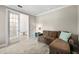 Relaxing sitting room with sectional sofa and French doors at 5610 Rain Lily Ct, Sarasota, FL 34238