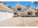 Front view of a house with a three-car garage and a landscaped yard at 6018 93Rd Street E Cir, Bradenton, FL 34202