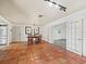 Dining room with a wooden table and chairs, terracotta tile flooring, and access to another room at 633 Chevy Chase Dr, Sarasota, FL 34243