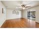 Living room with bamboo floors, sliding glass door leading to the backyard, and neutral decor at 633 Chevy Chase Dr, Sarasota, FL 34243