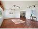 Bright living room with terracotta tile flooring, white walls, and track lighting at 633 Chevy Chase Dr, Sarasota, FL 34243