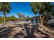 Backyard with a screened-in patio, palm trees, and a dock at 6536 Sabal Dr, Sarasota, FL 34242