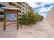 Sandy path leading to beach access with signage and foliage at 6536 Sabal Dr, Sarasota, FL 34242