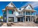 Modern two-story beach home with blue siding and white trim under construction at 6536 Sabal Dr, Sarasota, FL 34242