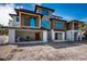 Modern, multi-story home with mixed wood and light-colored siding and open garage at 6536 Sabal Dr, Sarasota, FL 34242