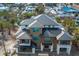 Modern house under construction, featuring a dark metal roof and wood siding at 6536 Sabal Dr, Sarasota, FL 34242