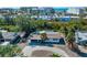 Aerial view of a home nestled among trees, with a circular driveway and glimpses of nearby buildings at 6536 Sabal Dr, Sarasota, FL 34242