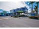 Modern retail building with ample parking and signage for various businesses at 6536 Sabal Dr, Sarasota, FL 34242