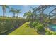 Landscaped backyard with pool and tropical plants at 6670 Horned Owl Pl, Sarasota, FL 34241