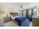 Spacious bedroom with ceiling fan and en-suite bathroom at 7708 Camminare Dr, Sarasota, FL 34238