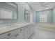 Bathroom with double vanity, soaking tub, and large mirror at 8111 Fairhaven Glen, University Park, FL 34201