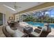 Spacious pool area with seating, dining, and screened enclosure at 8111 Fairhaven Glen, University Park, FL 34201