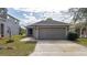 Exterior view of a one-story house with gray siding and a single garage at 10215 36Th E Ct, Parrish, FL 34219