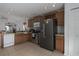 Kitchen with wood cabinets, black appliances, and tiled floor at 10215 36Th E Ct, Parrish, FL 34219