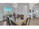 Bright dining room with a glass-top table and modern chandelier at 12515 Galapagos Ct, Venice, FL 34293