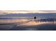 Couple walking on the beach at sunset at 1305 4Th St # 502A, Sarasota, FL 34236