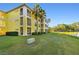 Building exterior showcasing yellow building and landscaping at 2060 Willow Hammock Cir # 304, Punta Gorda, FL 33983