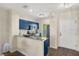 Modern kitchen with blue cabinets, granite countertops, and stainless steel appliances at 2060 Willow Hammock Cir # 304, Punta Gorda, FL 33983