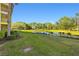 Landscaped backyard with pond view and lush greenery at 2060 Willow Hammock Cir # 304, Punta Gorda, FL 33983