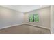 Bright bedroom with wood-look floors and a window with blinds at 26903 Pavin Dr, Englewood, FL 34223