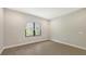 Simple bedroom featuring wood-look floors and a window with blinds at 26903 Pavin Dr, Englewood, FL 34223