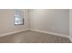 Well-lit bedroom with wood-look floors and a window with blinds at 26903 Pavin Dr, Englewood, FL 34223