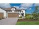 Two-car garage with paver driveway and nicely landscaped front yard at 26903 Pavin Dr, Englewood, FL 34223