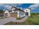 Two-car garage with paver driveway and nicely landscaped front yard at 26903 Pavin Dr, Englewood, FL 34223